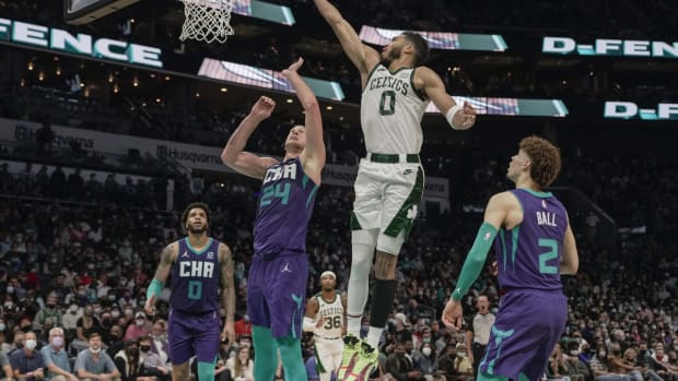 Oct 25, 2021; Charlotte, North Carolina, USA; Boston Celtics forward Jayson Tatum (0) goes up for a layup over Charlotte Hornets center Mason Plumlee (24) during overtime at the Spectrum Center. Mandatory Credit: Jim Dedmon-USA TODAY Sports